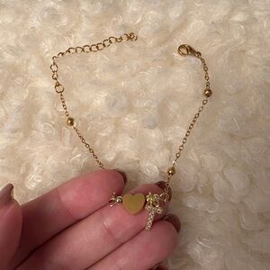 NWOT gold colored bracelet with heart and crystal letter T